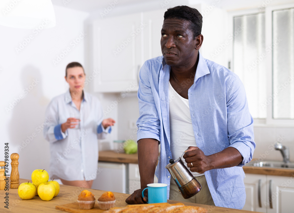 Domestic quarrel of husband and wife in kitchen during breakfast Domestic quarrel of husband and wife in kitchen during breakfast