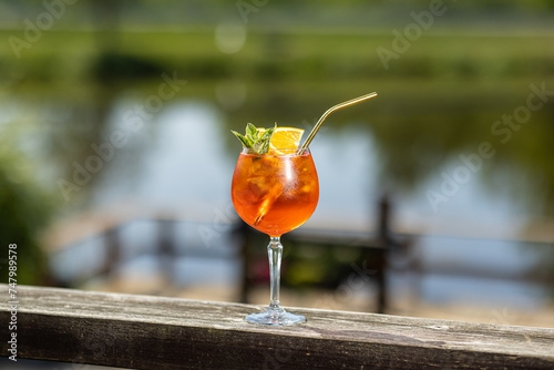 glass of aperol spritz cocktail in sunny day
