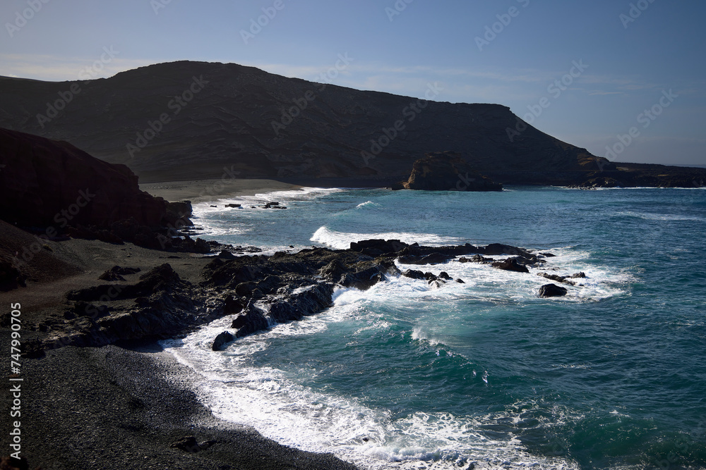 Sea and rocks. Cliffs in El Golfo, a coastal village on the island of Lanzarote (Spain).