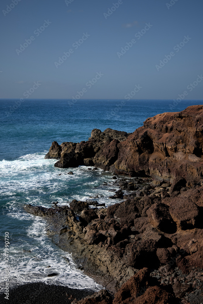 Sea and rocks. Cliffs in El Golfo, a coastal village on the island of Lanzarote (Spain).