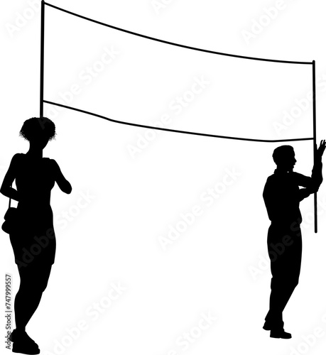 Two protestors or demonstrators at a demonstration march, picket line or strike protest rally in silhouette. Holding up a banner sign.