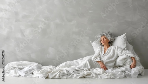 Tranquil senior woman peacefully sleeping in a white bed at home, with space for text placement.