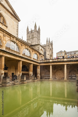 Tourists visiting inside Roman Baths complex. The City of Bath is a UNESCO World Heritage Site.