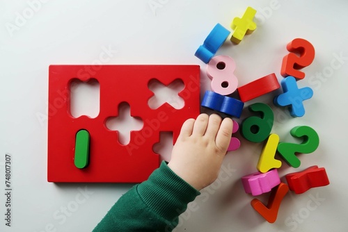 child playing with puzzle pieces