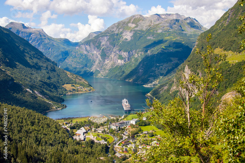 Landscape view across the town of Geiranger and the Fjord with a cruise ship  photo