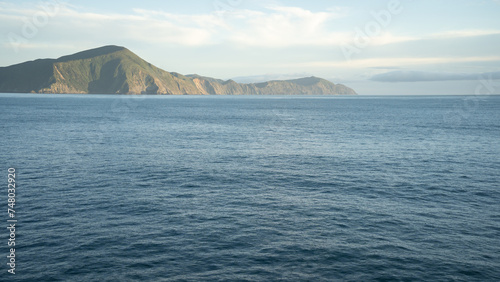 View on hilly landscape from passing transport boat during its sail, New Zealand © Peter Kolejak