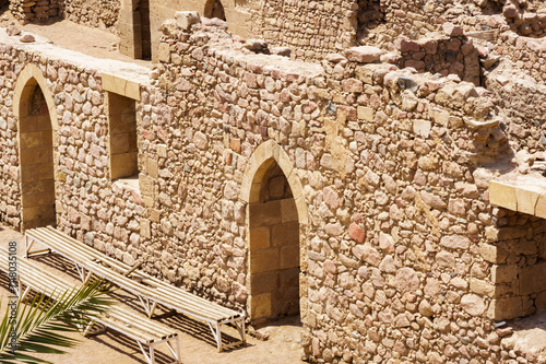 Antick ruins of Aqaba Fortress walls, or Aqaba Castle, Mamluk Castle, Jordan. Fortress was built by Crusaders in the 12th century. Aqaba Castle has quadrangular shape with stone towers at corners. photo