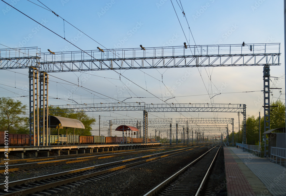 View of the railway and infrastructure and power lines at sunset
