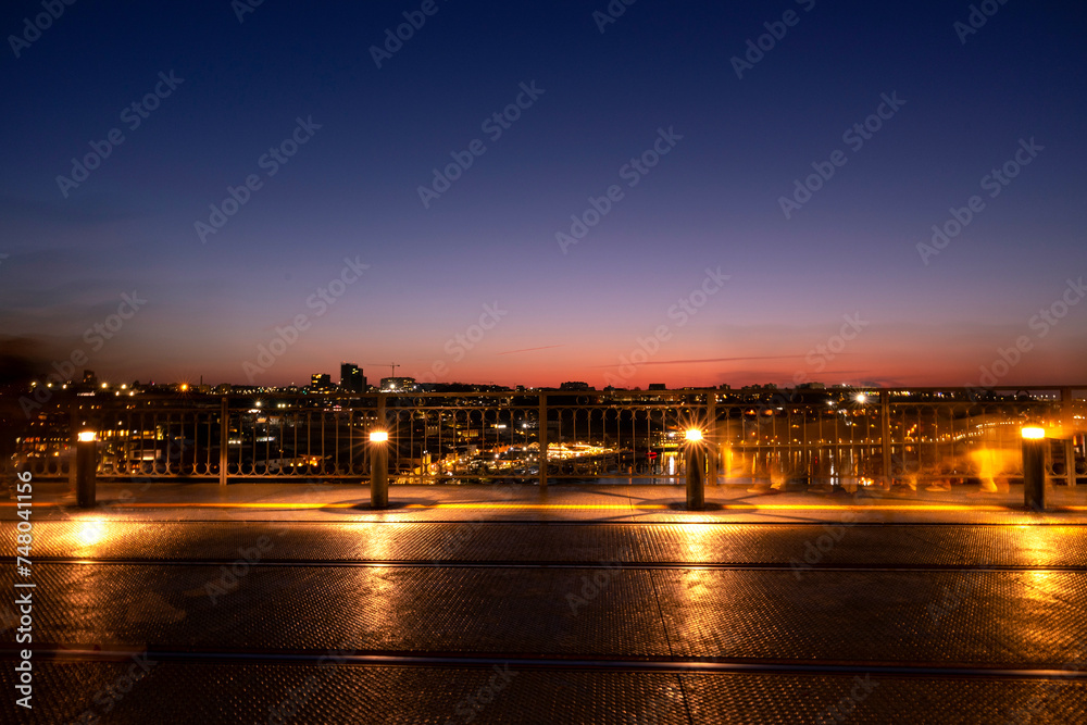 Panoramic view at dusk over the metro deck of D. Luís I bridge with the Douro river in the background. City of Porto in Portugal. Long Exposure.