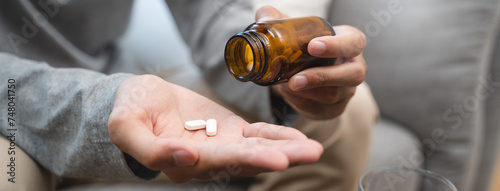 Tableau sur toile Close-up a medicine tablet in young man hand taking painkiller