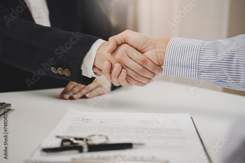 hands of agent and client shaking hands after signed contract buy new apartment.