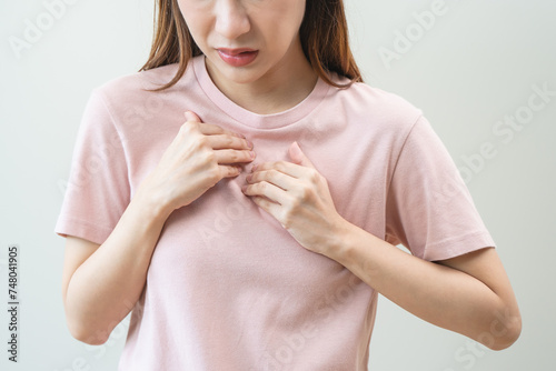 Acid reflux disease, suffer asian young woman have symptom gastroesophageal, esophageal, stomach ache and heartburn pain hand on chest from digestion problem after eat food, Healthcare medical concept © Pormezz