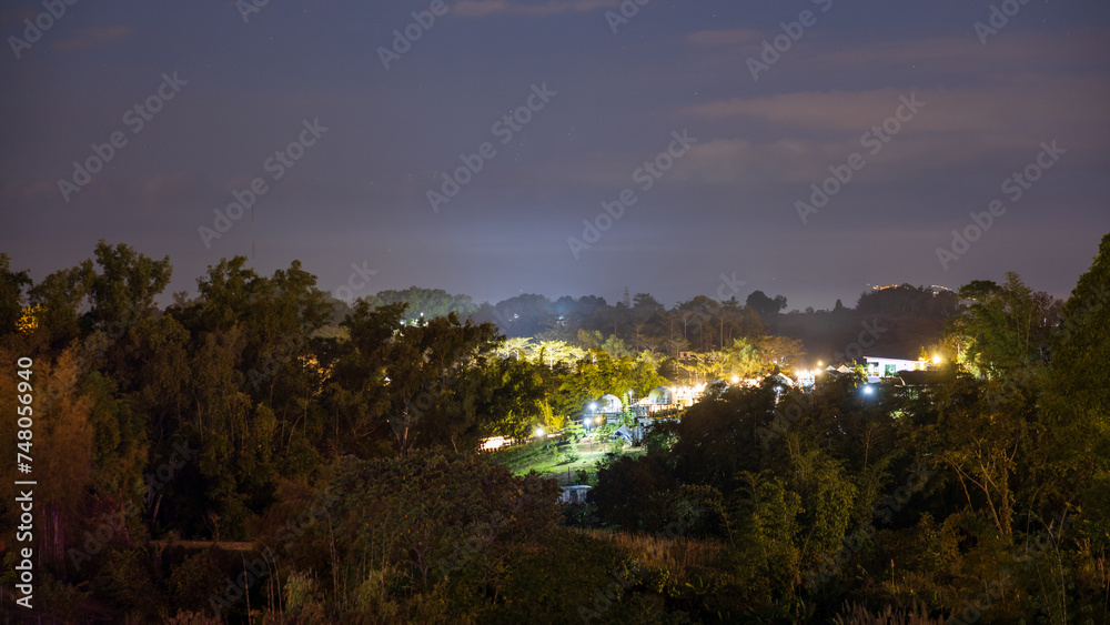 The view of twinkling lights from the many residential houses nestled on hills.