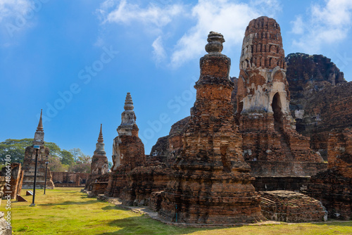 Exterior of ancient pagodas at Wat Mahathat in Ayutthaya Historical Park under cloudy sky  Thailand