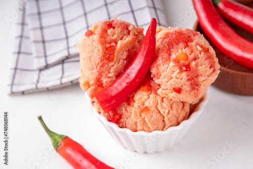 Chilli Pepper Ice Cream Sundae with chilli sweet and spicy jam topping. Unusual savory ice cream gelato recipe, with fresh chilli peppers