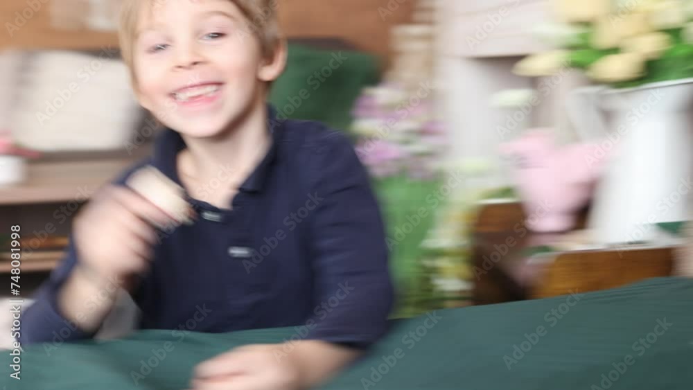 Beautiful blond child, boy, holding box with sweet macaroons for valentin Beautiful blond child, boy, holding box with sweet macaroons for valentin