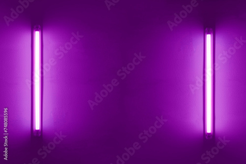 Two purple neon bulbs on white wall. Background texture of empty old wall with glowing purple neon lamps.