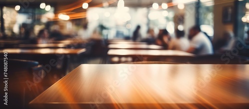A table in a restaurant is captured in a blur  showcasing the interior atmosphere. The focus is on the table setting and decor  creating a sense of depth and movement.