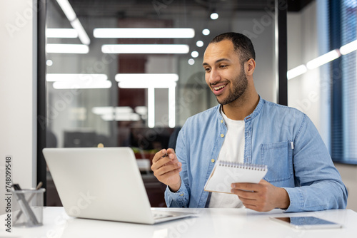 Professional man at work in a modern office space looking concentrated