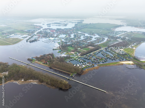 High quality photo of town of Terherne, Friesland, in winter with ice and frozen Sneekermeer photo