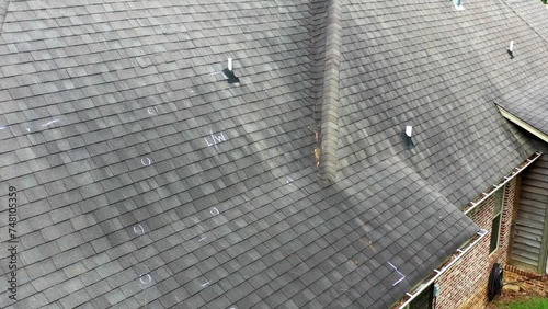 Roof with hail damage and markings from inspection photo