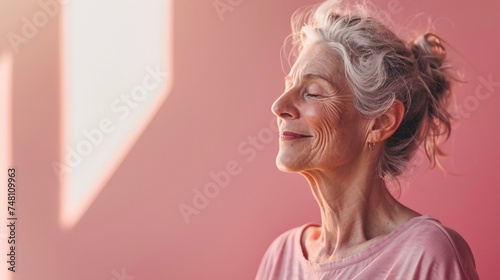 Senior woman smiling with her eyes closed in meditation as she enjoys a moment of inner peace