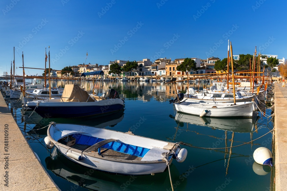 colourful fishing boats and the historic waterfront of Portocolom in eastern Mallorca