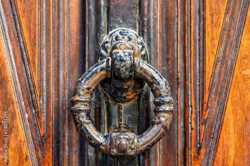 Ancient door knocker and decoration on a entrance door, Alicante
