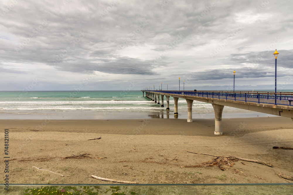 The New Brighton pier in Christchurch, New Zealand, looking out toward the Pacific Ocean.