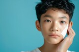 Asian boy s beauty concept involving skincare and cosmetics