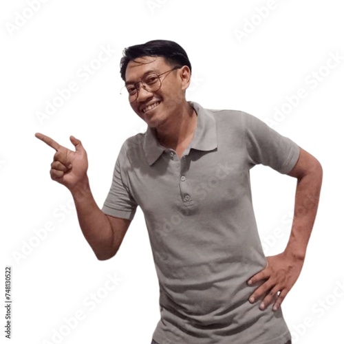 Excited Asian man wearing grey t-shirt pointing at the copy space on top of him, isolated by white background