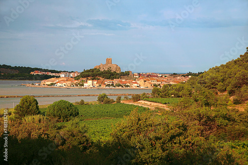 Distant view of Gruissan village, Tour de Barbarousse (Redbeard's Tower) and l'Étang de Gruissan from l'Île Saint Martin, on the Mediterranean coast of Southern France