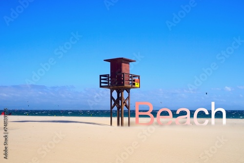 lifeguard tower at a wonderful beach, rose to white beach lettering with shadow next to it, Atlantic Ocean, Costa de la Luz, Andalusia, Spain photo