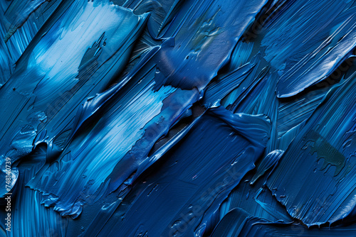 Detailed close-up view of a textured blue paint surface, showcasing intricate brush strokes and varying shades of blue.