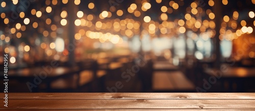 A wooden table is prominently featured in the foreground of the image, with a background consisting of abstract, blurry lights from a restaurant setting.