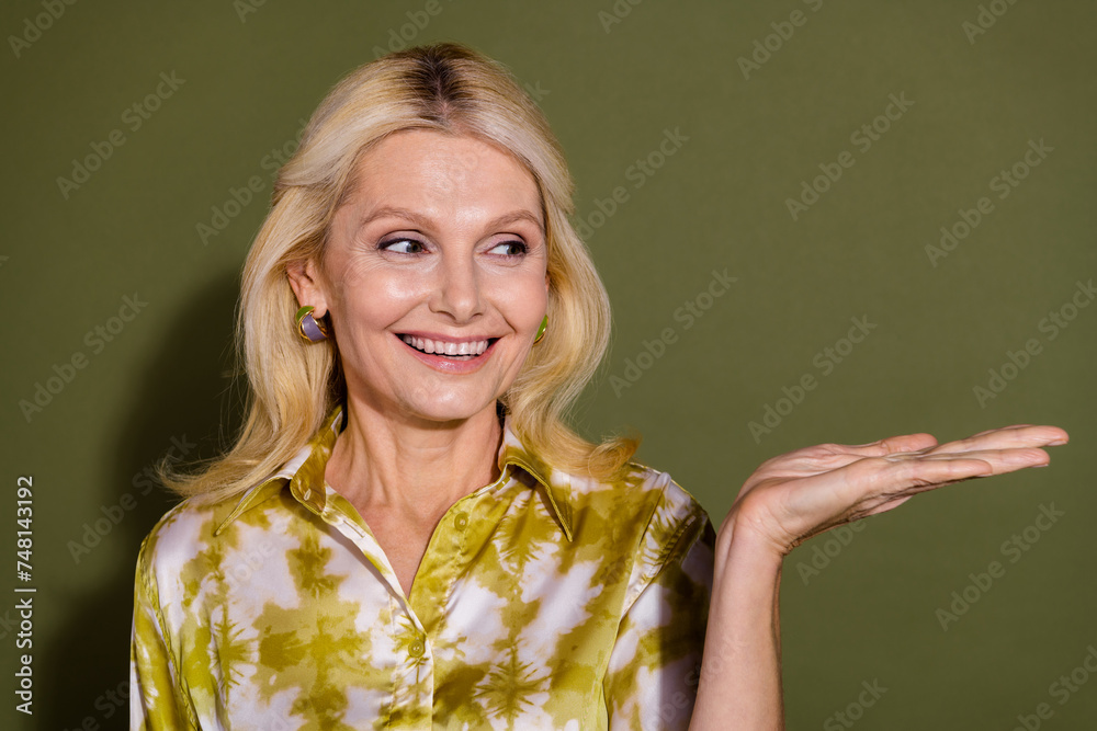 Photo of stunning lovely pretty lady hold beauty product advertise novelty brand logo empty space ad isolated on khaki color background Photo of stunning lovely pretty lady hold beauty product advertise novelty brand logo empty space ad isolated on khaki color background