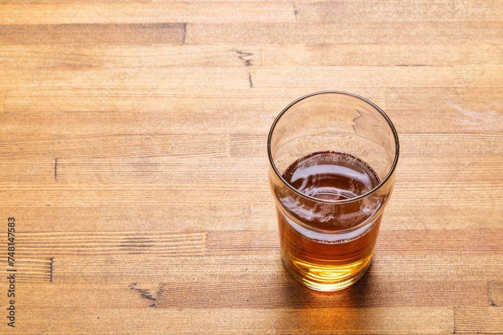 Craft beer in pint glass on a wooden table Craft beer in pint glass on a wooden table