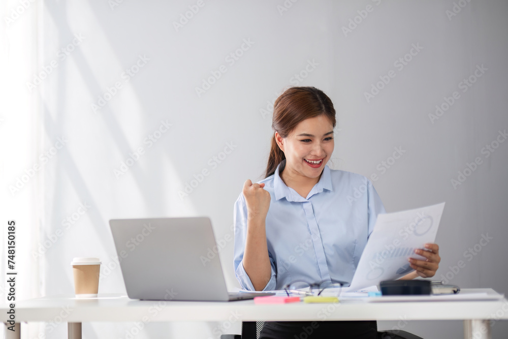 Happy middle-aged businesswoman working in the office. Businesswoman working on laptop and using in remote online job interview meeting on laptop. Happy middle-aged businesswoman working in the office. Businesswoman working on laptop and using in remote online job interview meeting on laptop.