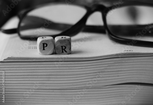 Public relations letters on open book photo