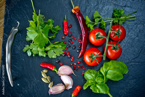 Chilli, garlic, coriander, tomatoes, basil, parsley, cardamon and pepper corns photo