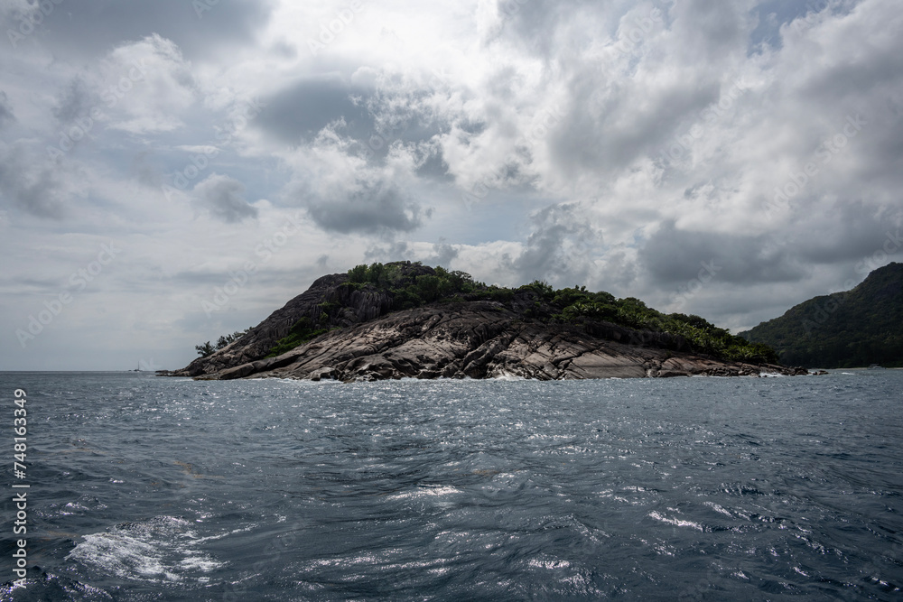 landscape with a beautiful coastline with huge stones on the beaches on a sunny day on one of the Seychelles islands