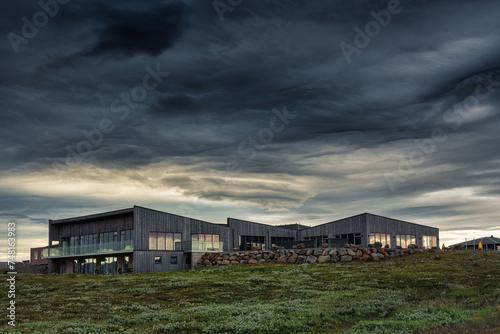 Visitor Gullfoss tourist centre with brandname shop, restaurant, souvenir and information service with dramatic sky on gloomy day © Mumemories