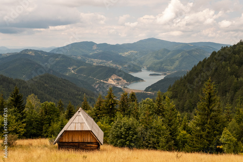Cottage surrounded by forest high in the mountain with view on the lake, Zaovine, Tara, Serbia photo