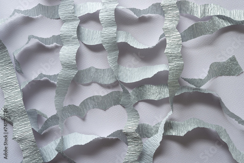 overlapping metallic silver crepe paper stripes with wavy edges on textured paper