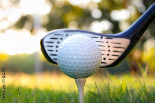 Golf ball set on tee with green bokeh background