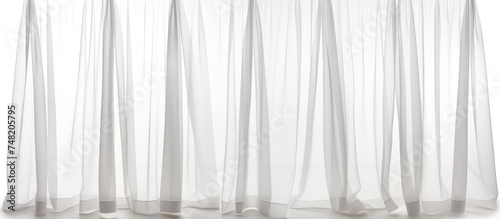 A white curtain with sheer fabric is seen hanging, creating a delicate and airy ambiance. The sheer fabric adds a subtle texture to the curtain, giving a soft and elegant touch to the room.