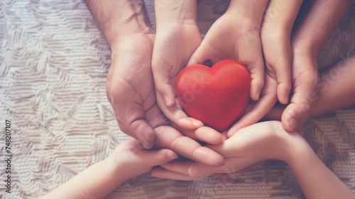 Family Hands Holding Red Heart