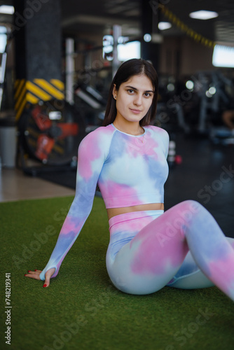 Fitness woman sitting at the gym