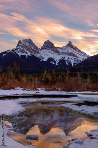 Winter sunset at The Three Sisters, a trio of peaks near Canmore, Alberta, Canada.