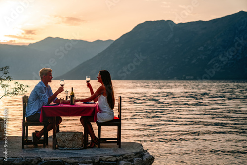 Honeymoon couple is having a private, romantic dinner at a tropical beach